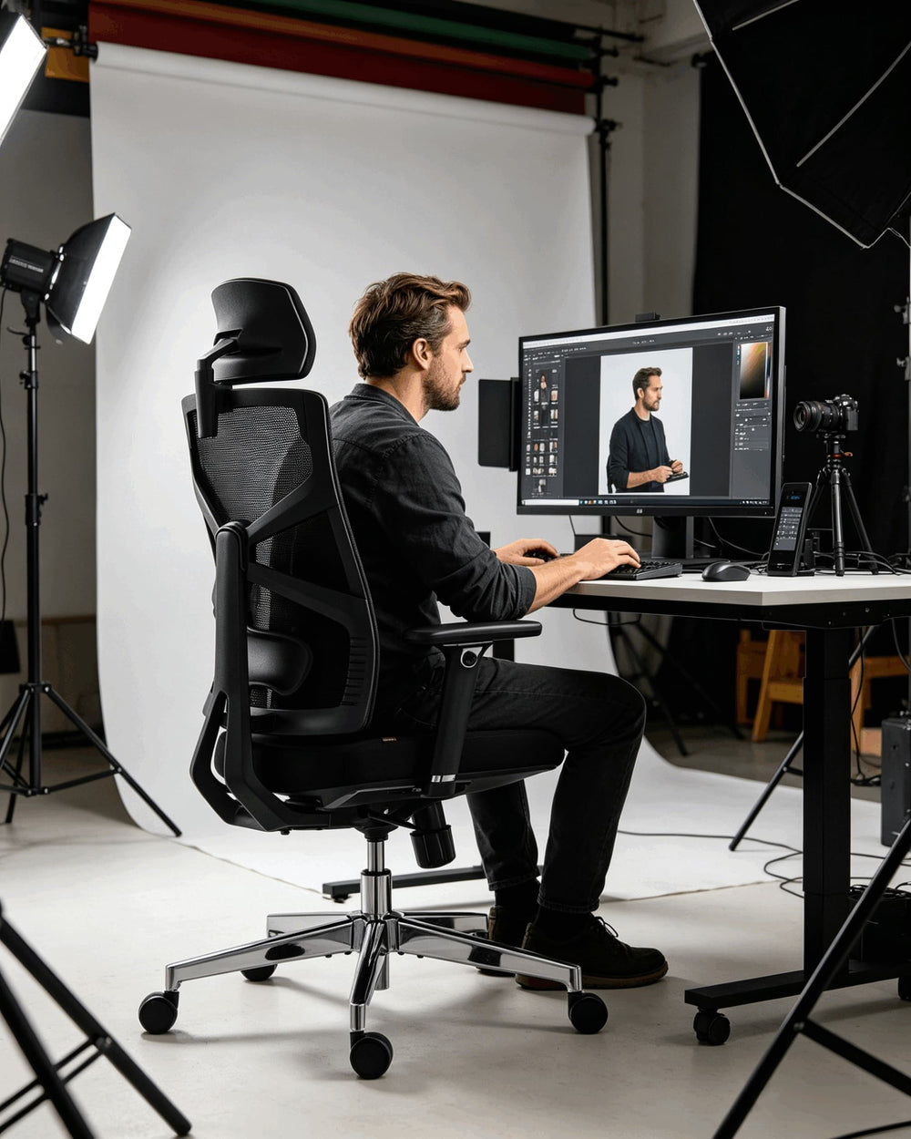 Photo editor retouching images in professional photography studio seated in HOLLUDLE Shaper black ergonomic chair