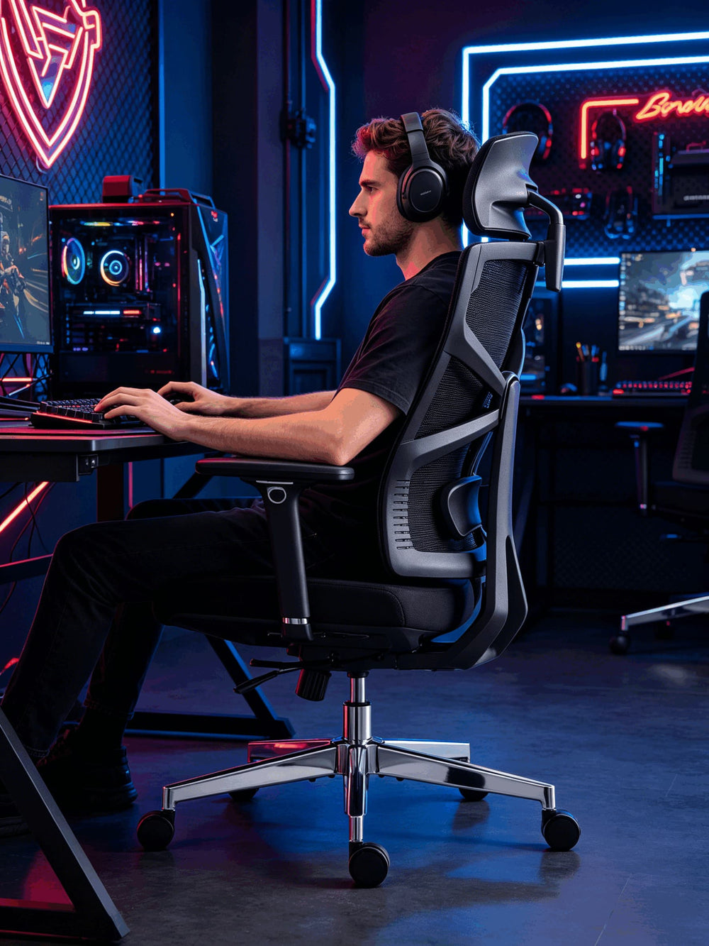 Gamer with headphones focused on monitor seated in HOLLUDLE Shaper black ergonomic chair side view in gaming room