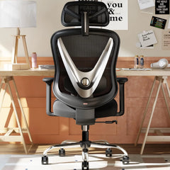 HOLLUDLE V Chair black ergonomic office chair with silver V-shaped backrest frame and adjustable headrest at wooden trestle desk in cozy Scandinavian study room